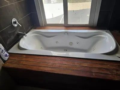a bath tub in a bathroom with a window at Silkes Villa in Hurghada