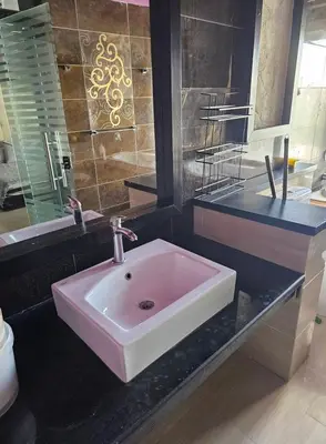 a bathroom with a pink sink and a mirror at Silkes Villa in Hurghada