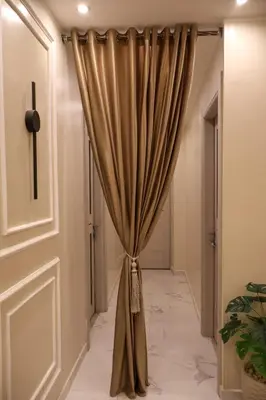 a curtain in a hallway next to a door at Cozy Luxe Apartment in Central Aswan in Aswan