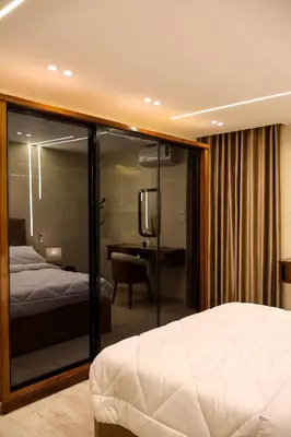 a bedroom with a bed and a television in a room at Cozy Luxe Apartment in Central Aswan in Aswan