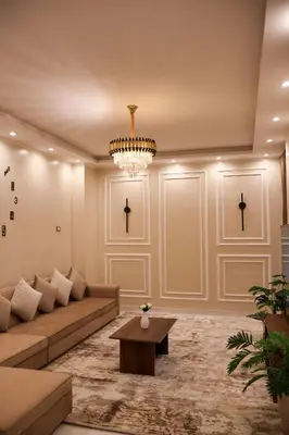 a living room with a couch and a chandelier at Cozy Luxe Apartment in Central Aswan in Aswan