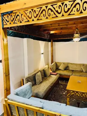 a living room with a couch and a table at Quiet Villa in Luxor