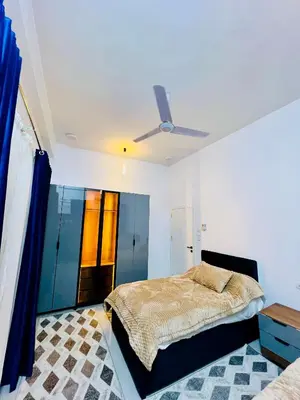 a bedroom with a bed and a ceiling fan at Quiet Villa in Luxor