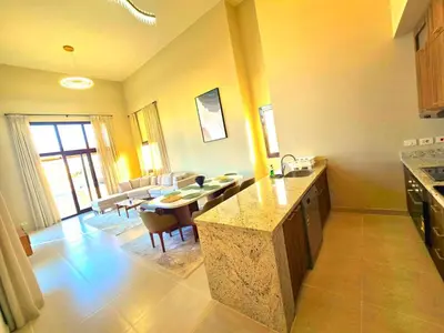 a kitchen and living room with a table and a dining room at El Gouna Cyan the Range 4BDs Villa with private Pool in Hurghada