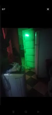 a room with a green light and a cabinet at قنا الشؤن in Qena