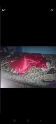 a person sleeping on a bed under a red blanket at قنا الشؤن in Qena