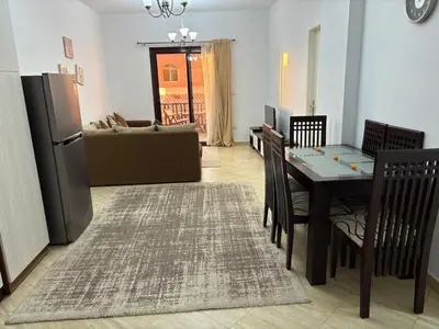a kitchen and living room with a table and chairs at Amaizing 2BR Apartment B2 in Turtles Beach - Hurghada in Hurghada