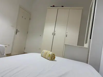 a white bedroom with a white bed and white cabinets at Amaizing 2BR Apartment B2 in Turtles Beach - Hurghada in Hurghada