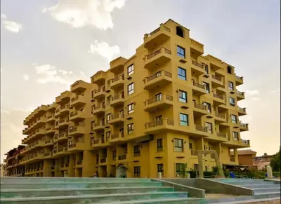a yellow building with balconies on the side of it at Amaizing 2BR Apartment B2 in Turtles Beach - Hurghada in Hurghada