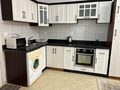 a kitchen with white cabinets and a washer and dryer at Amaizing 2BR Apartment B2 in Turtles Beach - Hurghada in Hurghada