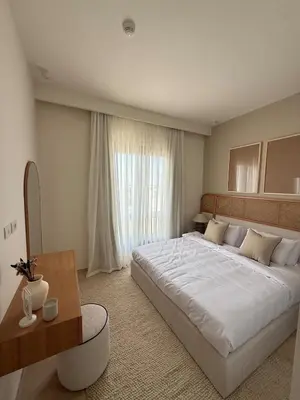 a bedroom with a large white bed and a window at Ancient Sands Resort Gouna 1 Bedroom apartment with open view in Hurghada