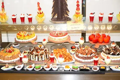 a display of cakes and other desserts on a table at Chalets 980 in Mirage resort in Hurghada