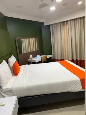 a bedroom with a large bed and a desk at Nile Plaza Suites in Aswan