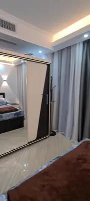 a mirror in a bedroom with a bed and a bed sqor at Cecelia Resort in Hurghada