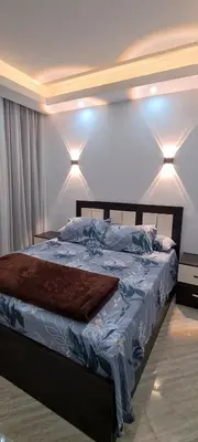 a bed in a bedroom with lights on the wall at Cecelia Resort in Hurghada