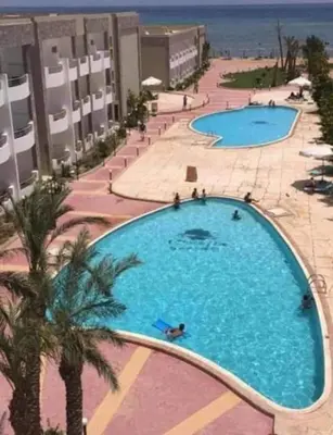 an overhead view of a large swimming pool at a resort at Cecelia Resort in Hurghada