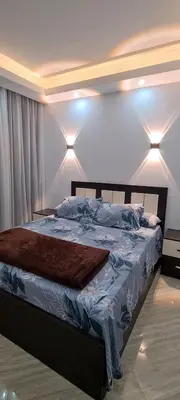 a bedroom with a large bed with lights on it at Cecelia Resort in Hurghada
