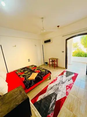a bedroom with a bed and a table in it at Luxor Old nile apartment in Luxor