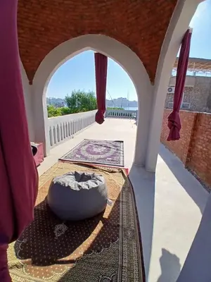 a view from the balcony of a room with a table at ARKN angel Nubian Guest House in Jazīrat al ‘Awwāmīyah