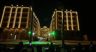 a group of buildings at night with green lights at Juliana Beach Resort Hurghada A105 in Hurghada