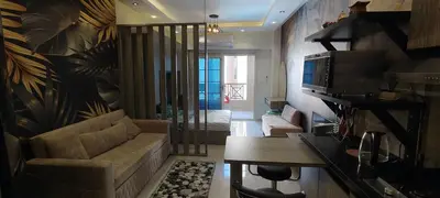 a living room with a couch and a television at Juliana Beach Resort Hurghada A105 in Hurghada