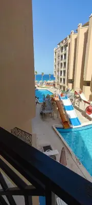 a view of a swimming pool from a balcony of a hotel at Juliana Beach Resort Hurghada A105 in Hurghada
