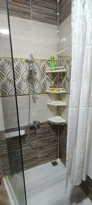 a shower with a glass door in a bathroom at Juliana Beach Resort Hurghada A105 in Hurghada