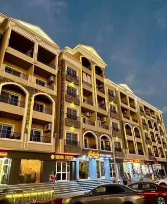 a large building with cars parked in front of it at Juliana Beach Resort Hurghada A105 in Hurghada