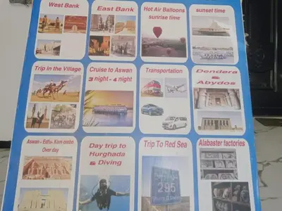 a sign with pictures of different sights and events at Karima house B in Al Aqālitah