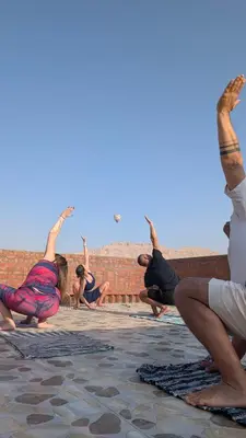 a group of people doing yoga on a wall at Karima house B in Al Aqālitah