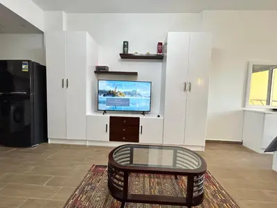 a living room with a tv and a coffee table at El Saraya Resort Chalet, Sahl Hasheesh in Hurghada