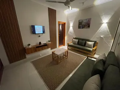 a living room with a couch and a tv at Luxe Nest Luxor Serviced Apartments 301 in Luxor