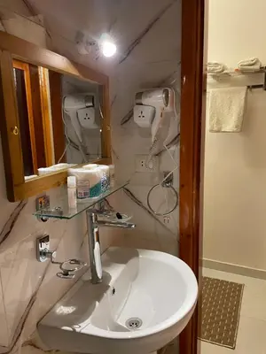 a bathroom with a sink and a mirror at Luxe Nest Luxor Serviced Apartments 301 in Luxor