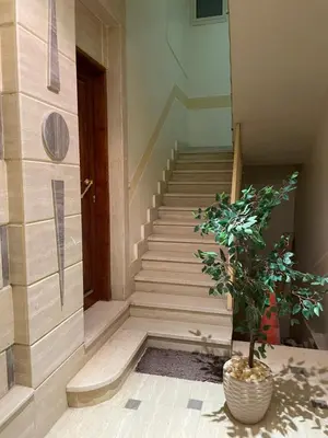 a staircase in a building with a potted plant at Luxe Nest Luxor Serviced Apartments 301 in Luxor