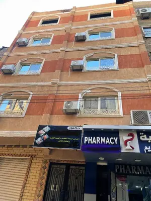 a building with a pharmacy sign in front of it at Luxe Nest Luxor Serviced Apartments 301 in Luxor