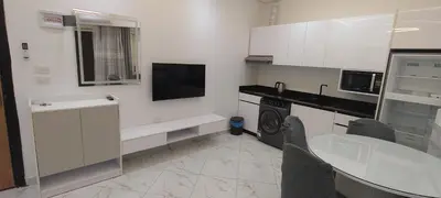 a kitchen with white cabinets and a washer and dryer at Juliana Beach Resort Hurghada AG10 in Hurghada