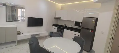 a kitchen with a table and a white table and chairs at Juliana Beach Resort Hurghada AG10 in Hurghada