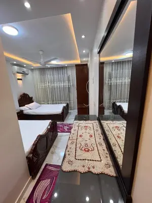 a view of a room with a bed and a rug at Flat in Nag` el-Ramla