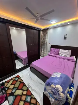 a bedroom with two beds and a mirror at Aswan in Nag` el-Ramla