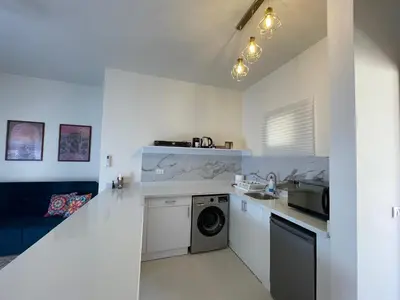 a kitchen with a washer and dryer in a room at Casa Esmeralda in Hurghada