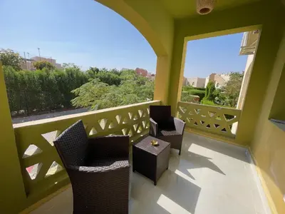 a balcony with chairs and a table and a window at Casa Esmeralda in Hurghada