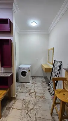 a room with a washing machine in the corner of a room at Saint charbel in Hurghada