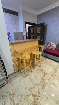 a wooden bar with two chairs and a piano at Saint charbel in Hurghada