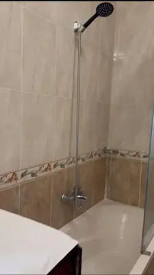a shower with a glass door in a bathroom at katakitu in Hurghada