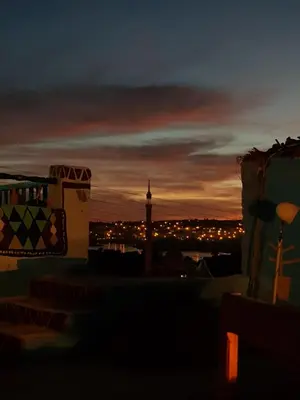 a view of a city at night with a clock tower at Seheil Antique House in Jazīrat Salūjah