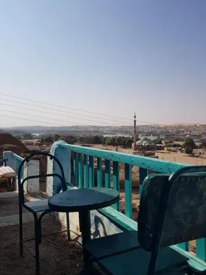 a table and a bench on a balcony with a view at Seheil Antique House in Jazīrat Salūjah