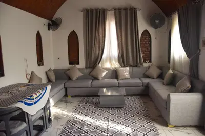 a living room with a couch and a table at Isis Magic House in Luxor
