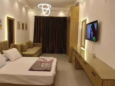 a hotel room with two beds and a flat screen tv at فلورانزا خمسين b06 in Hurghada