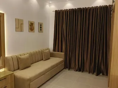 a living room with a couch and a curtain at فلورانزا خمسين b06 in Hurghada