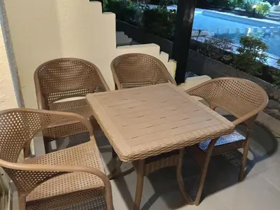 a wooden table and chairs on a balcony at فلورانزا خمسين b06 in Hurghada